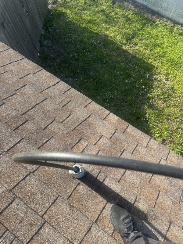 Jetting hose inserted in rooftop vent