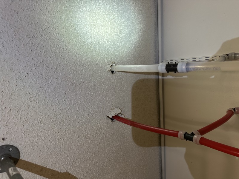 Ceiling view of red and white PEX water lines