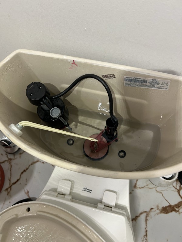 Completed toilet tank rebuild with new fill valve and flapper
