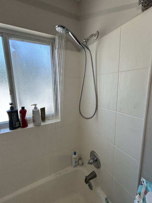 Newly installed shower fixture with water running