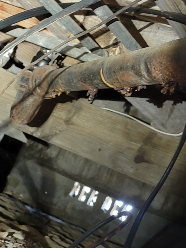 Close-up of rusted horizontal cast iron pipe