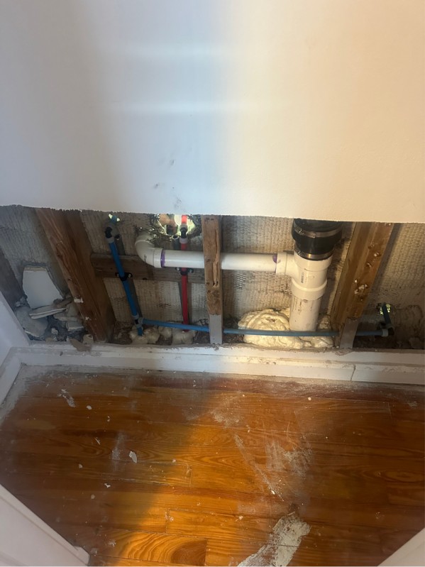 Wall cavity with new PEX and PVC plumbing