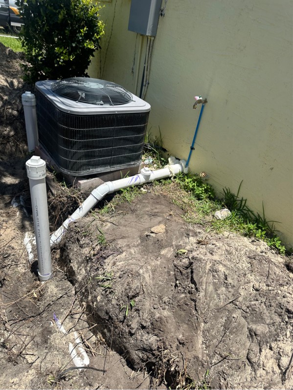 Outdoor trench with plumbing under HVAC