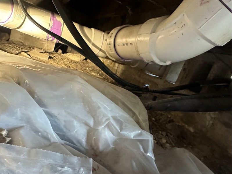 Long stretch of PVC plumbing in crawl space
