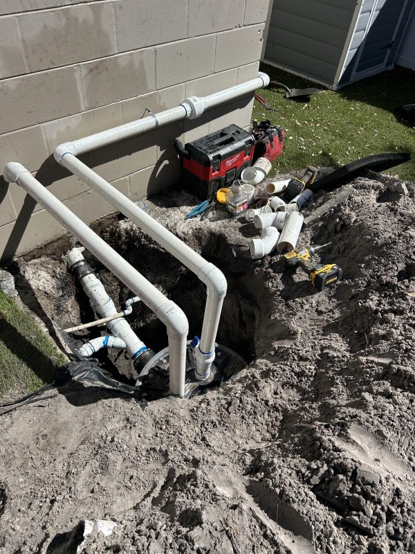 Sewage pump station with dual discharge lines and rubber couplings