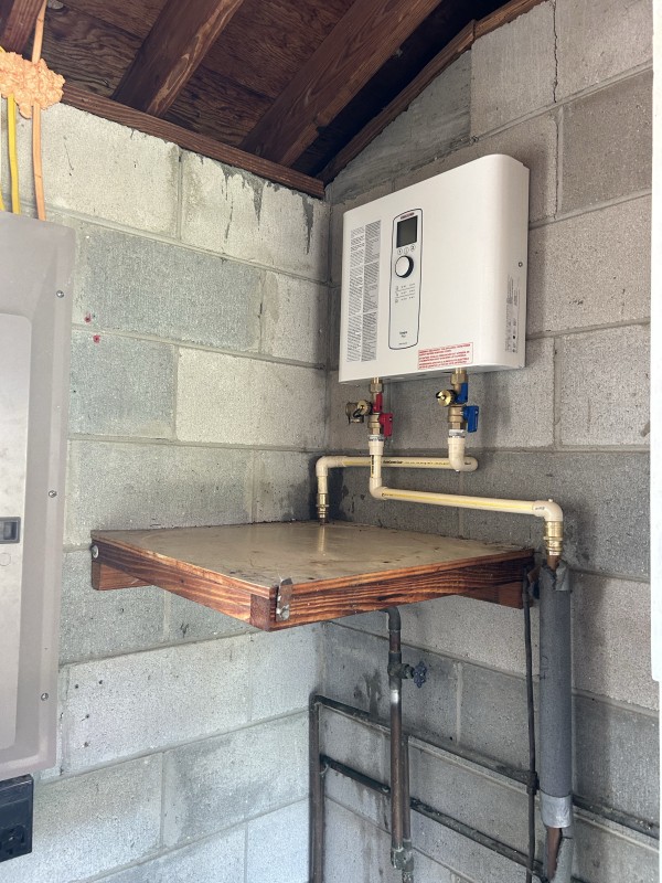 Tankless water heater positioned on wall mount