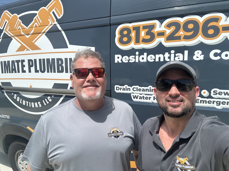 Plumber team in front of van
