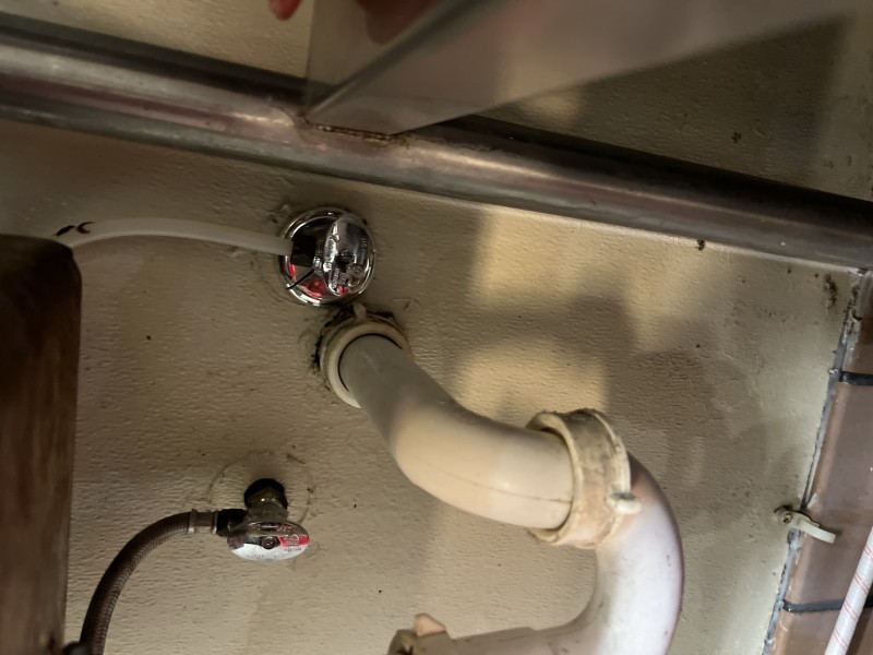 Plumber adjusting Sloan valve settings