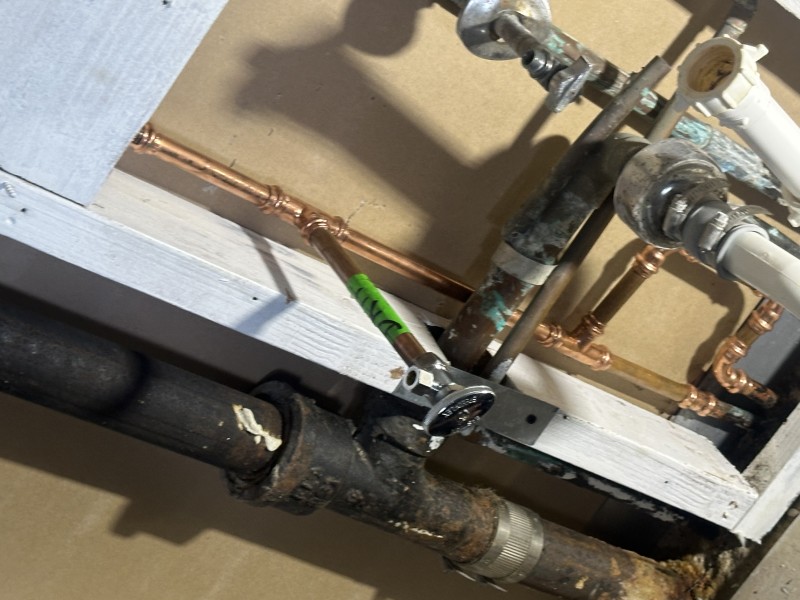 Completed copper manifold replacement neatly installed behind lavatory