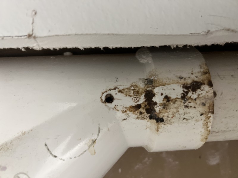 Drywall section cut open in closet to expose hidden water pipes