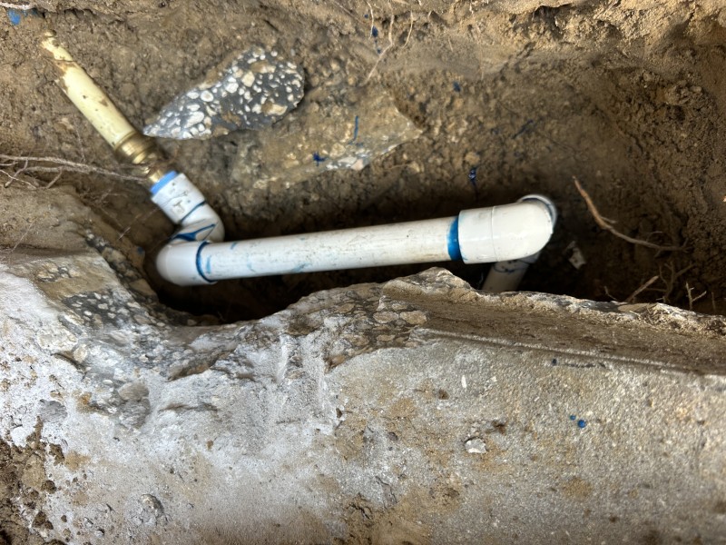 Installing the new rated transition coupling between PEX and PVC.
