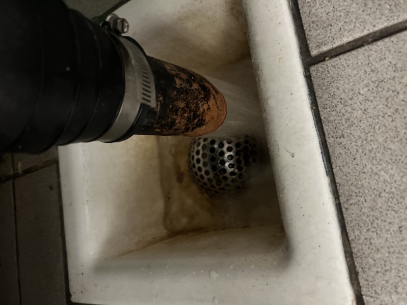 Flush testing commercial sink drains to verify restored flow after clog removal