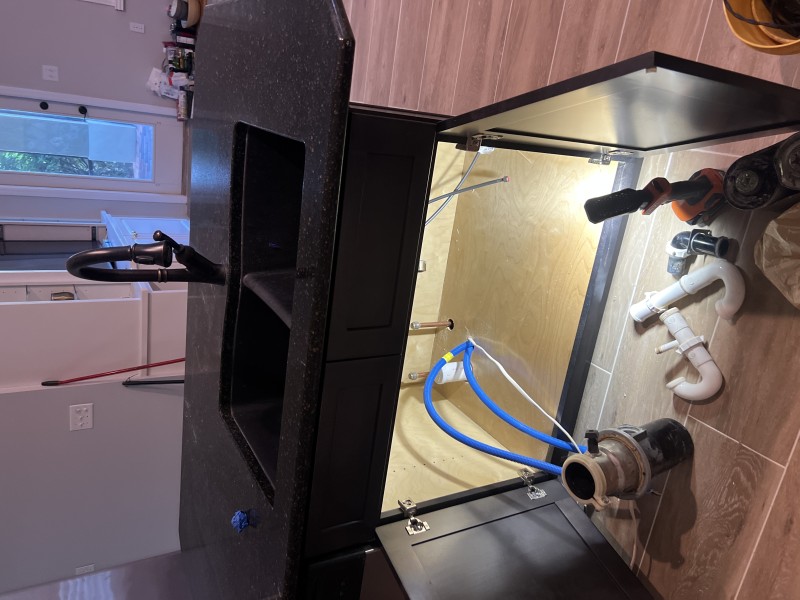 Assembling a tubular P-trap with flanged tailpiece and end outlet waste kit under the sink