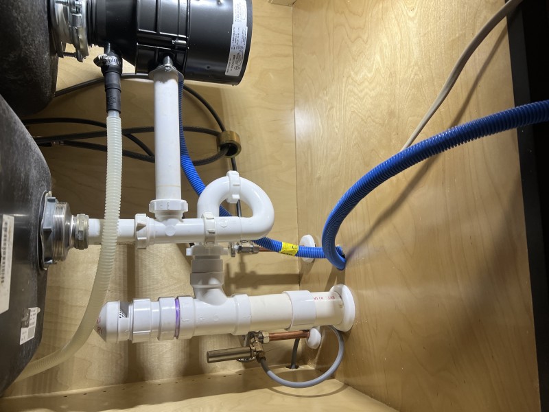 Mounting a garbage disposal and tying in the dishwasher discharge with a proper high loop
