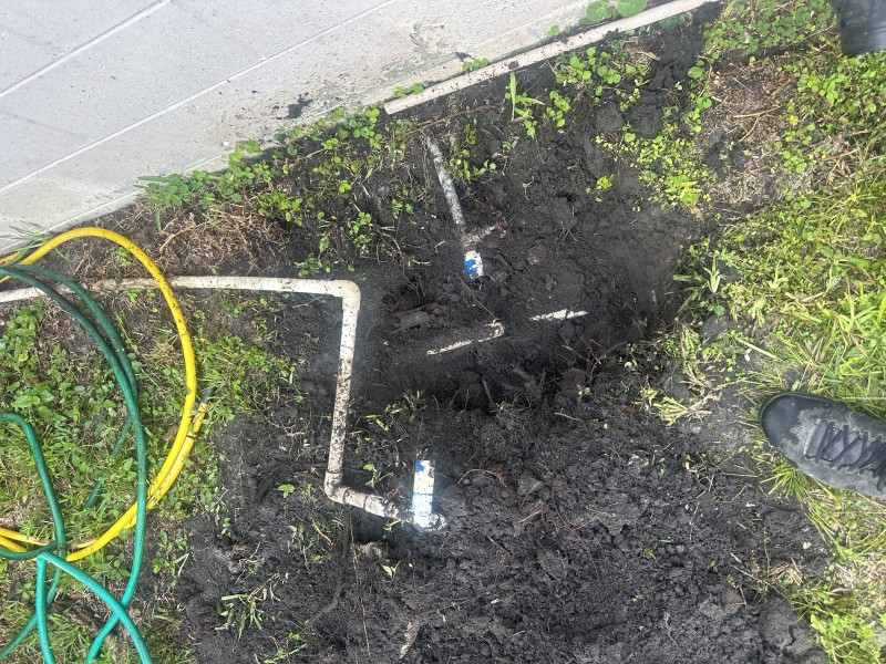 Broken sprinkler tee and separated PVC coupling before repair