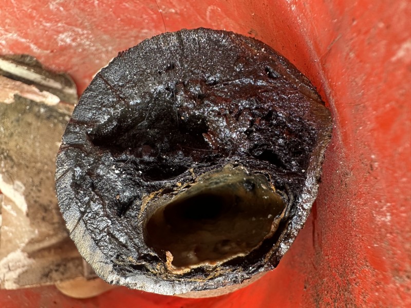Solvent welding PVC P-trap with primer and cement for watertight joints