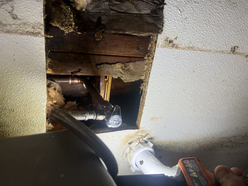 New copper pipe section soldered into place behind wall
