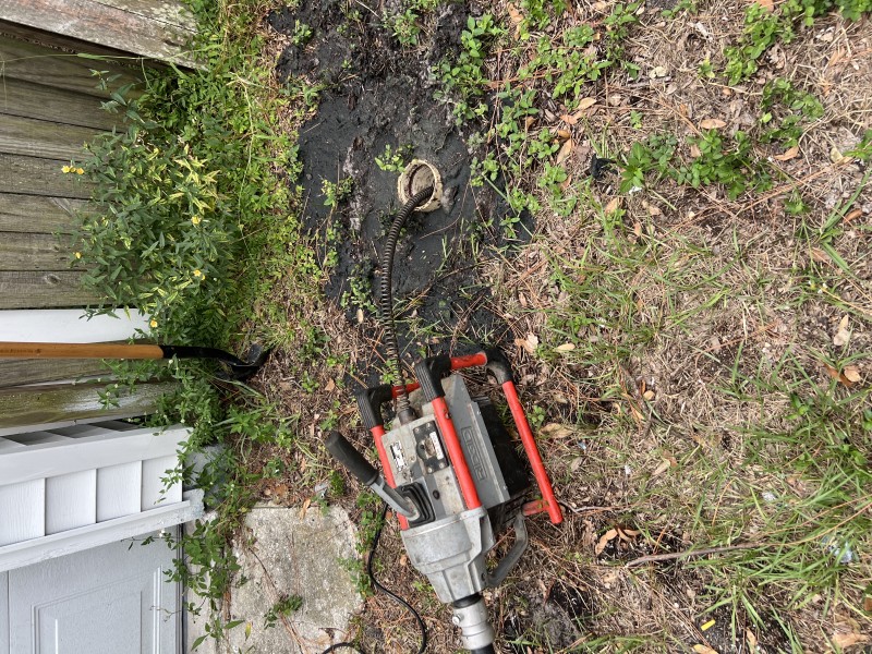 Toilet pulled to access flange; auger fed through for blockage verification prior to reset