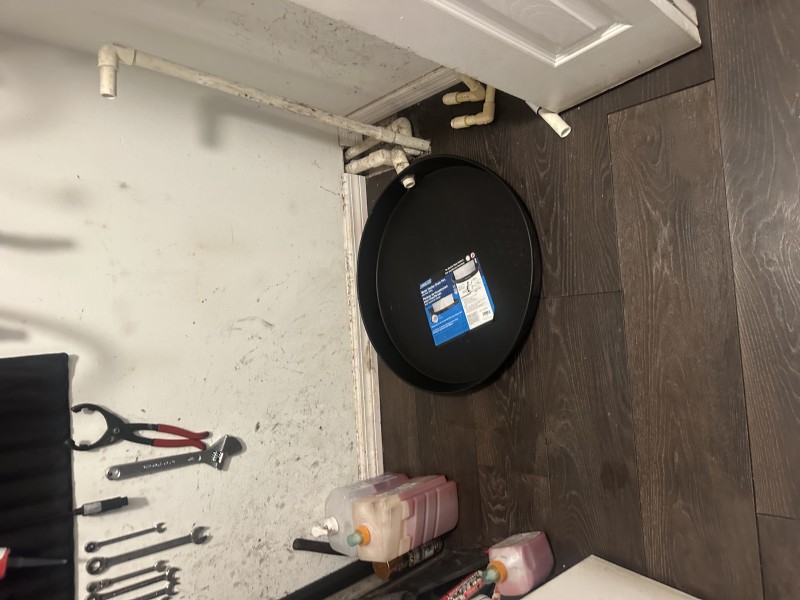 Removing old low-boy water heater and replacing corroded drain pan