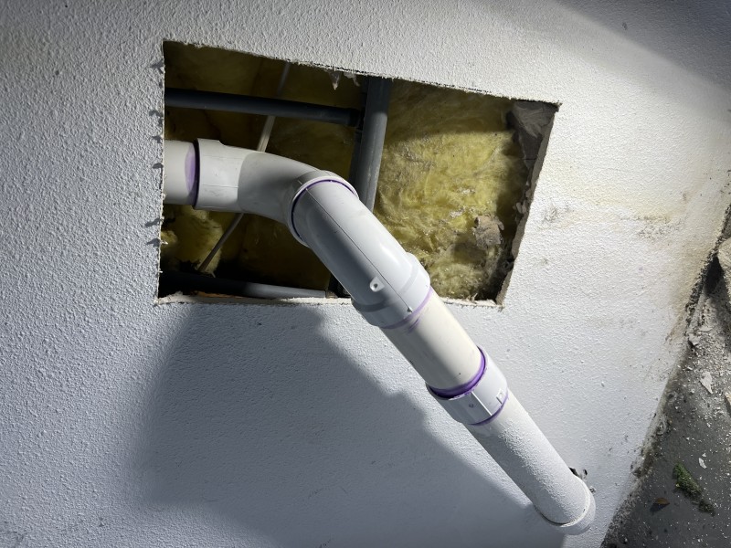 Completed washing machine drain repair after pressure and flow testing