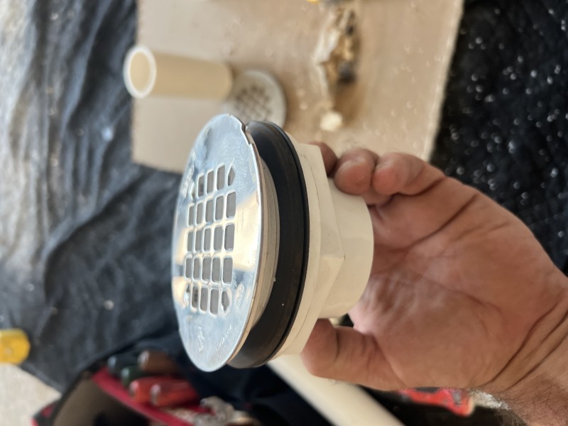 Inspecting shower drain and P-trap alignment before disassembly