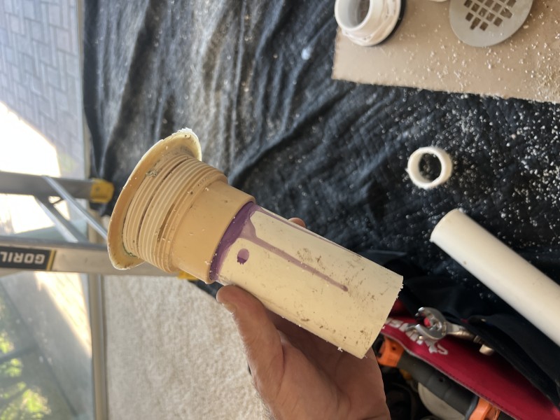 Removing worn shower drain components and cleaning area for repair