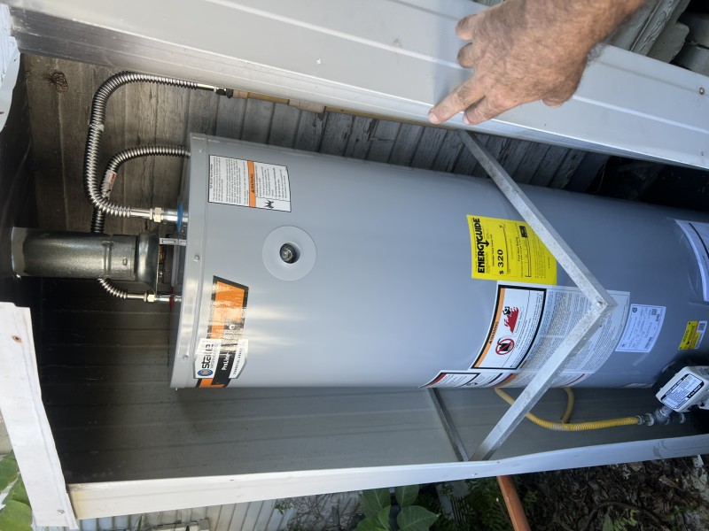 Close view of the water heater top with fittings and connections visible