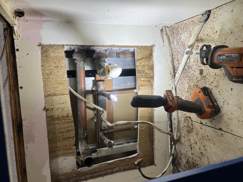 New drain and water lines stubbed back into the cabinet for clean installation