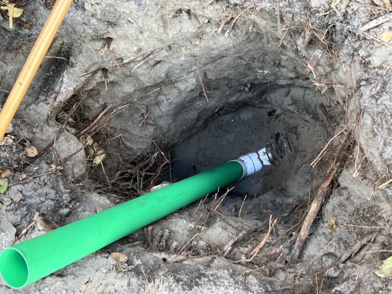 Existing sewer cleanout and piping exposed for inspection before replacement