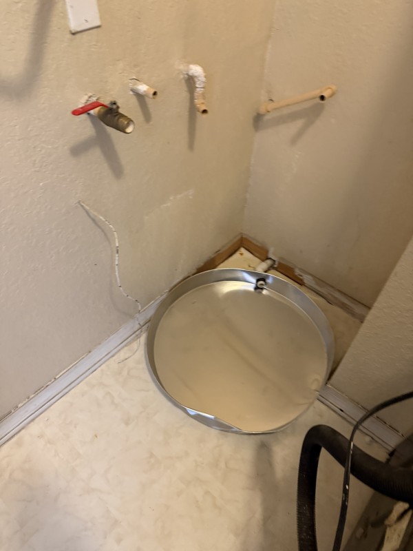 Plumber working on water lines and shutoff valve connections near the water heater, Riverview, FL, December 11, 2025