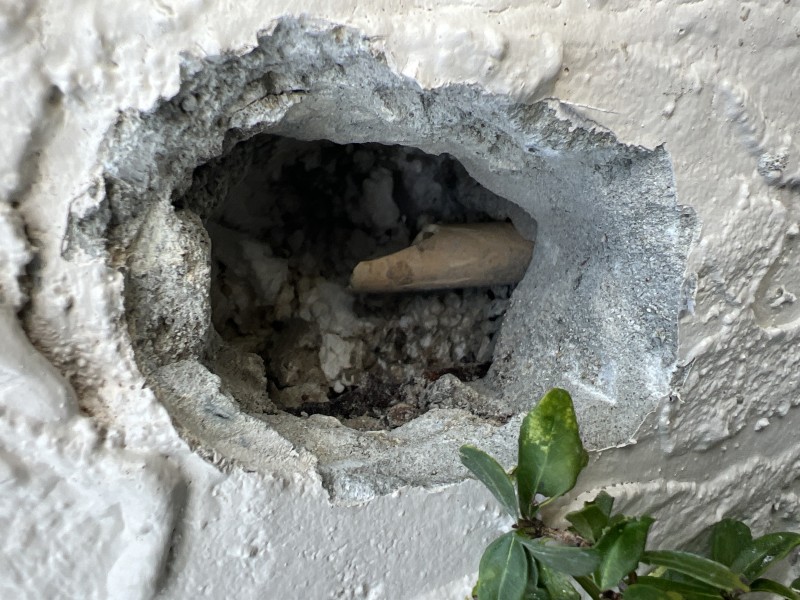 Wall opening exposing damaged pipe behind hose bib, Orlando, FL, December 2025