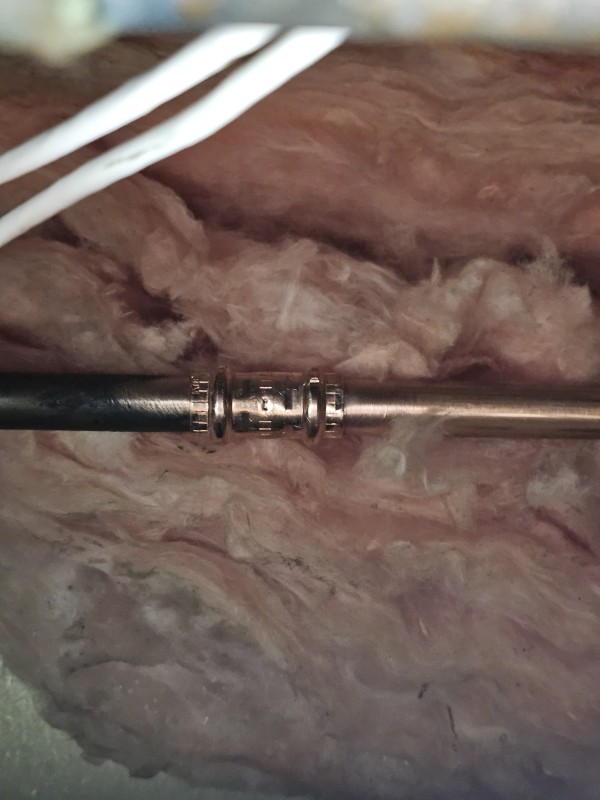 Copper press coupling tying new water line section into existing pipe, Brandon, FL, December 2025