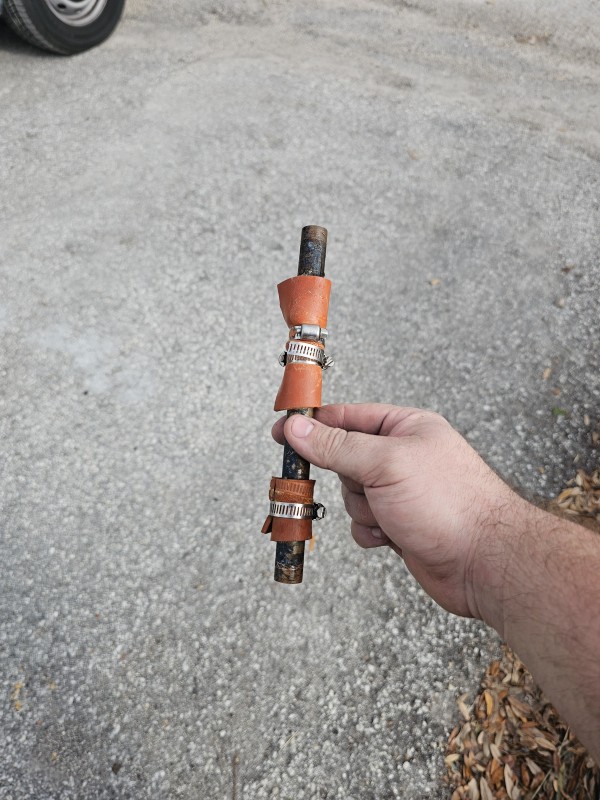 Removed rubber hose and clamp temporary repair from a copper water line, Brandon, FL, December 2025