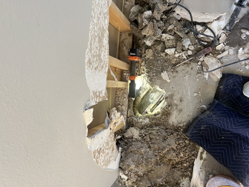Creating a controlled 12x12 concrete access opening to reach the under-slab plumbing line near the kitchen area, Valrico, FL, December 31, 2025