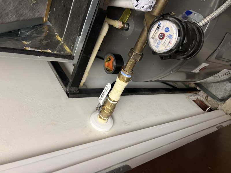 Wide view of the main shut-off assembly with the new 1-inch brass ball valve on CPVC piping after repairing an additional CPVC fitting leak, Tampa, FL, January 2026