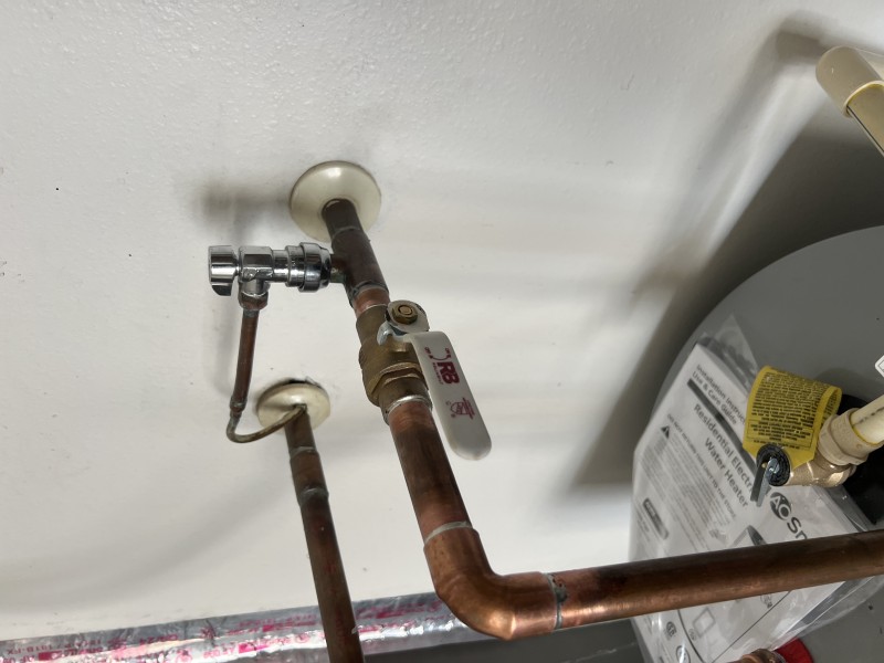Close-up of 3/4 inch brass ball valve installed on copper water line for water heater shutoff, Tampa, FL, January 2026