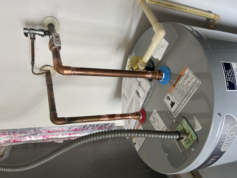 Finished water heater piping connections showing hot and cold lines and secure fittings after installation, Tampa, FL, January 2026