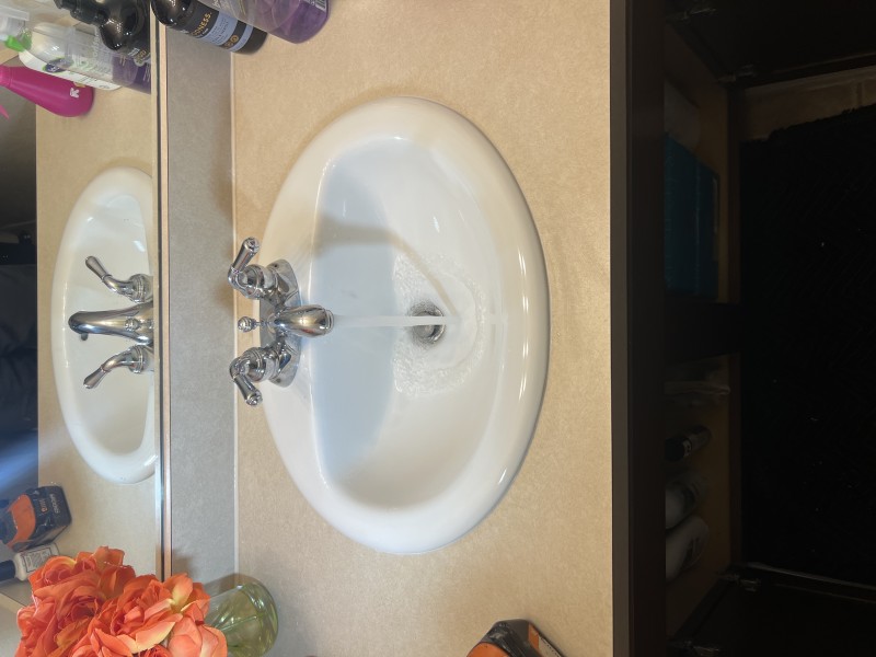 Jobsite photo of the completed white drop-in sink installation with the existing faucet reinstalled and plumbing tested for leaks, Pinellas Park, FL, January 26, 2026