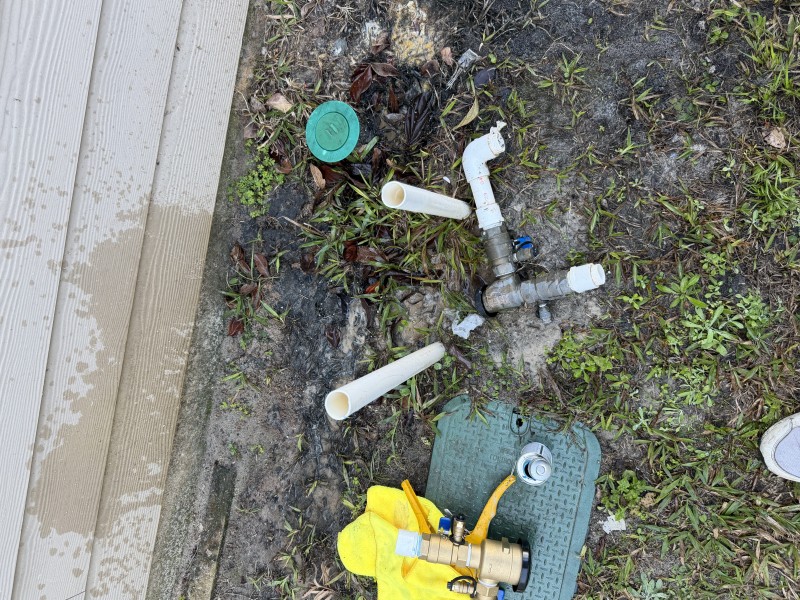 Opened exterior piping and repair area during RPZ backflow replacement showing preparation and leak repair work, Ocala FL February 2026