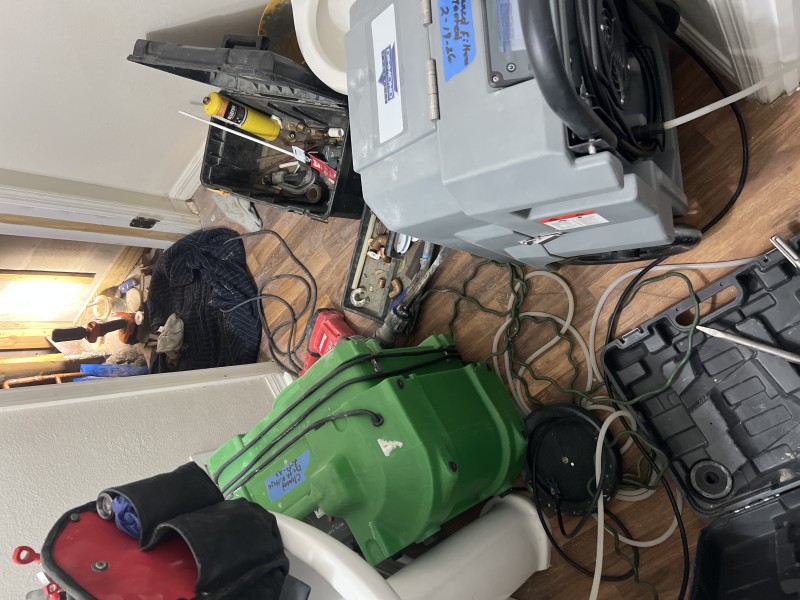 Work area showing tools, equipment, and plumbing access during slab leak repair, Riverview FL, February 26 2026