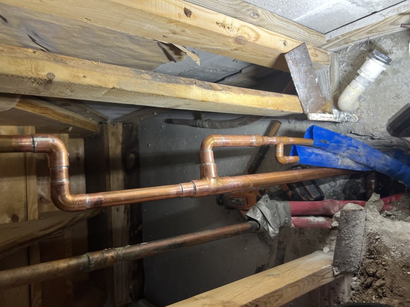 Copper piping exposed within wall framing near slab opening during repair, Riverview FL, February 26 2026