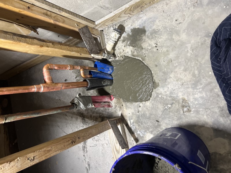 New copper pipe section installed at slab opening before backfill, Riverview FL, February 26 2026