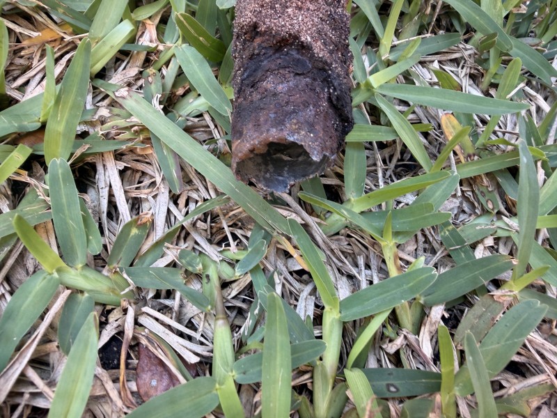 Close-up of a severely rusted and deteriorated gas pipe end removed from the ground, Davenport, FL, March 2026