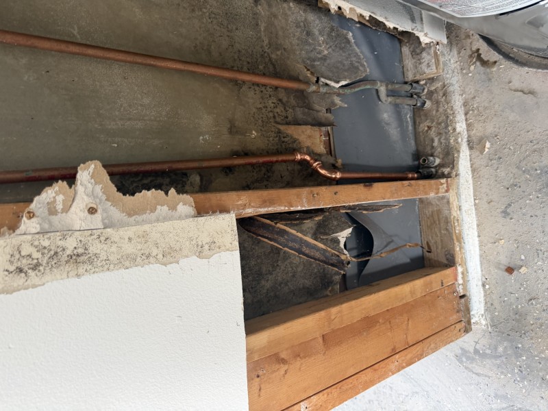 Exposed wall section with new copper piping route installed above slab level for reroute, Tampa, FL, March 2026