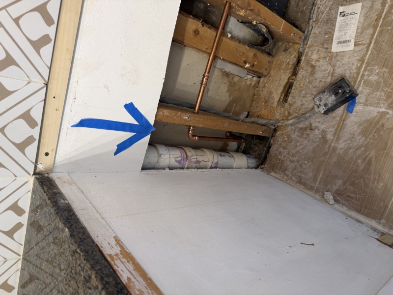 Final exposed plumbing reroute with directional indicator showing new supply line path, Tampa, FL, March 2026