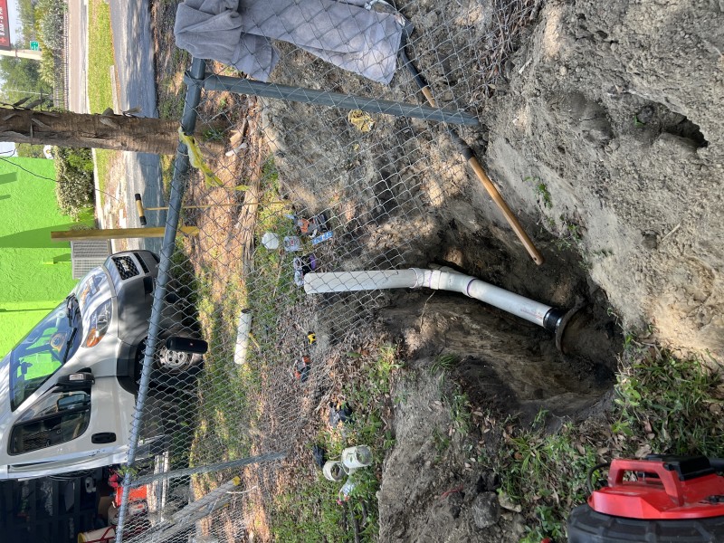 Fully exposed sewer line trench showing repair area and pipe layout, Florida, March 2026