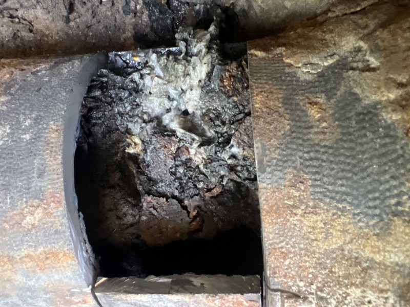 Close-up of removed cast iron wye showing debris buildup inside pipe, Zephyrhills FL, March 2026