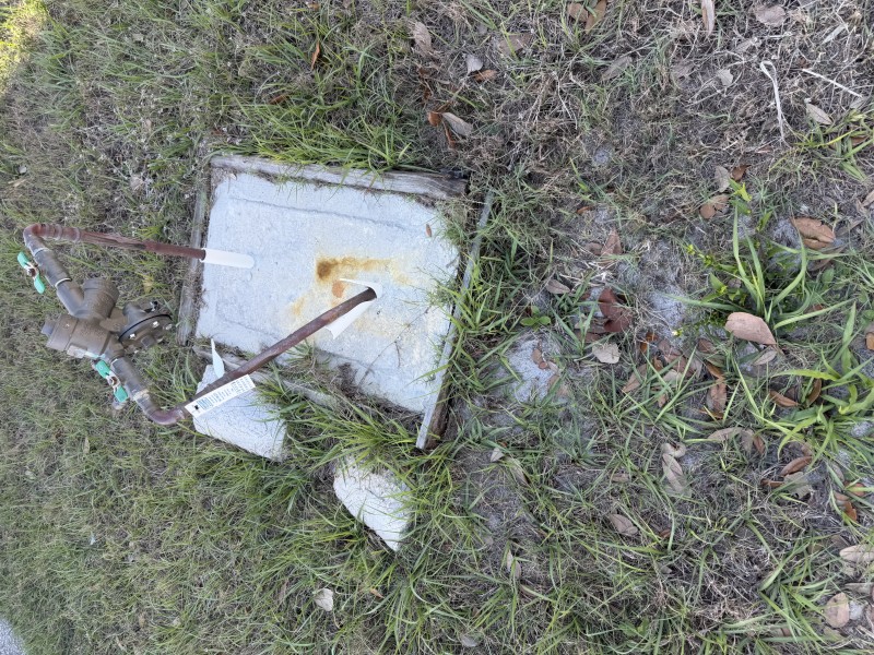 Excavation exposing underground copper water service line after concrete removal, Sarasota FL, April 2026