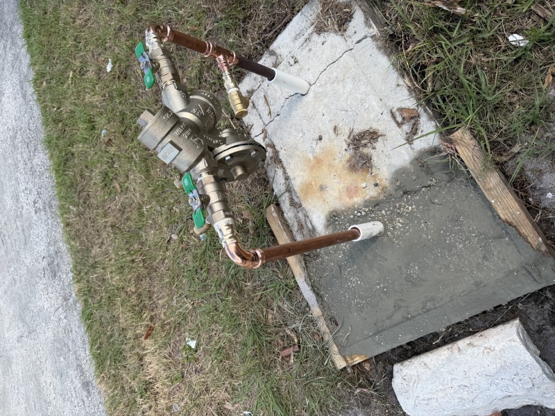 Concrete repoured around plumbing and backflow assembly, Sarasota FL, April 2026