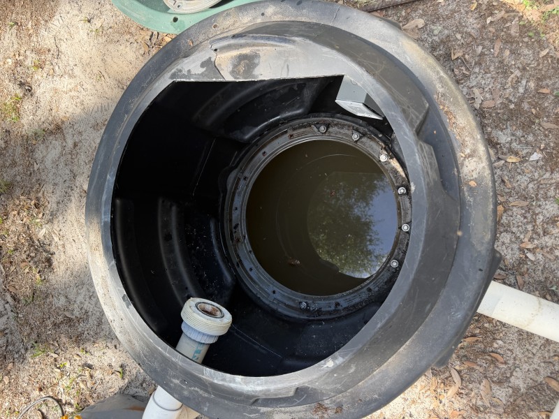 Open grinder pump basin showing wastewater chamber during inspection, Tampa Florida, April 2026